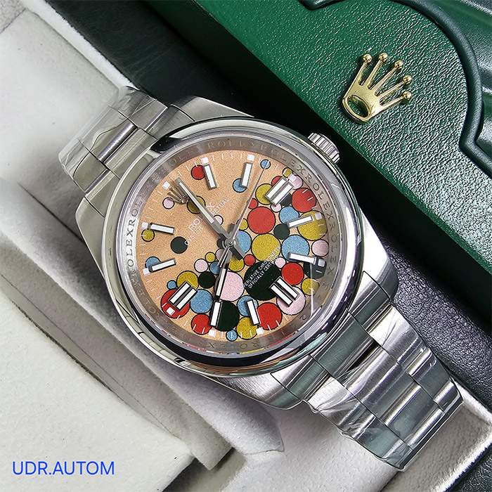Reloj Rolex Oyster Perpetual Edición Limitada con esfera rosa y diseño artístico colorido, brazalete Oyster de acero inoxidable, con ventana de fecha a las 3 y resistencia al agua de hasta 100 metros