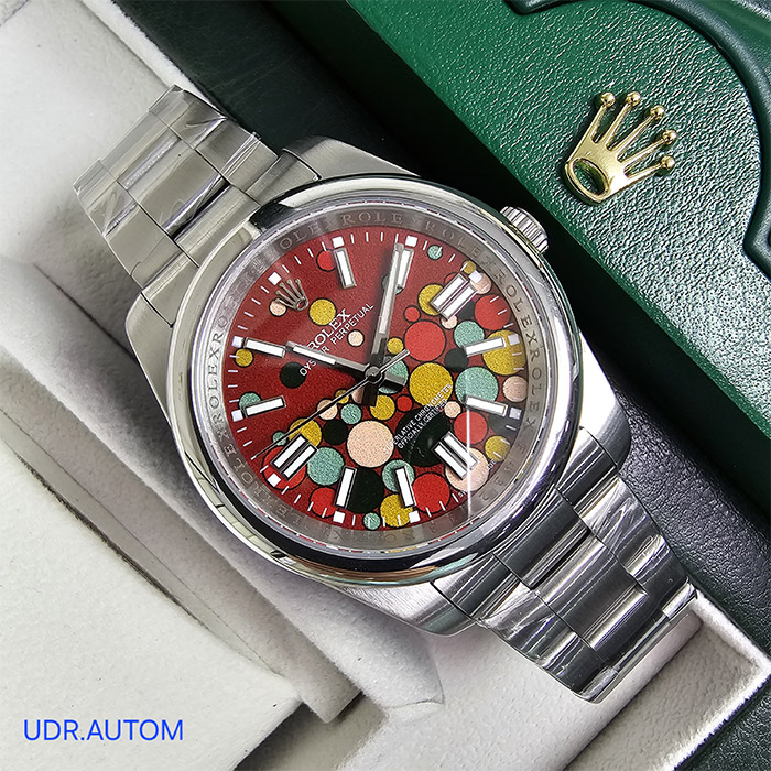 Reloj Rolex Oyster Perpetual con esfera roja y diseño artístico colorido, brazalete de acero inoxidable, ideal para quienes buscan un reloj elegante y moderno.
