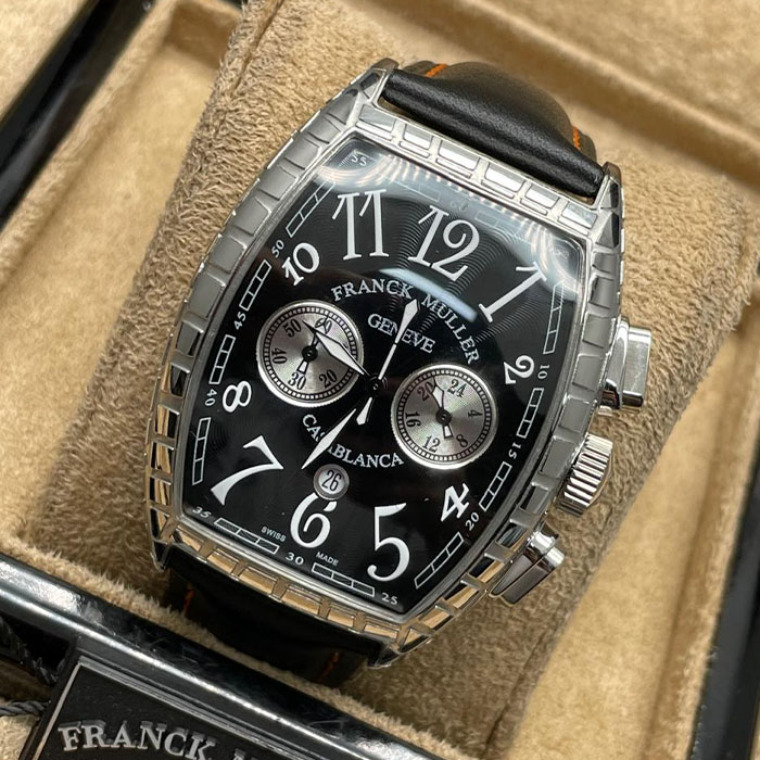 Franck Muller Geneve Casablanca, reloj deportivo de lujo con esfera negra, detalles plateados, correa de cuero negro y cronógrafo. Ideal para quienes buscan exclusividad y diseño sofisticado.
